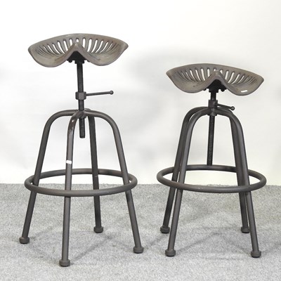 Lot 700 - A pair of metal tractor seat stools