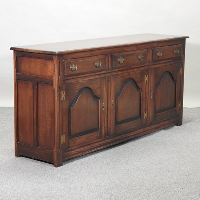 Lot 520 - A 20th century oak sideboard