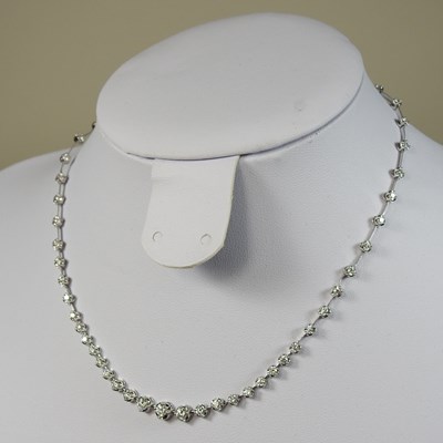 Lot 242 - An 18 carat white gold diamond line necklace
