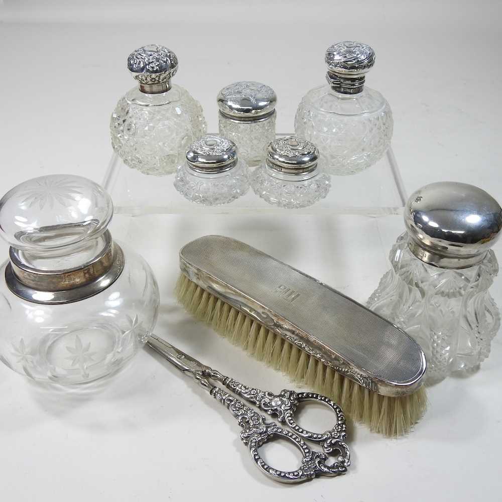 Lot 71 - A collection of silver mounted glass scent bottles
