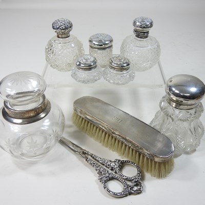 Lot 71 - A collection of silver mounted glass scent bottles