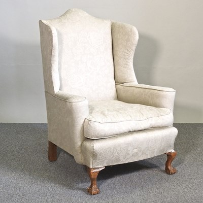 Lot 263 - A 1920's cream upholstered wing armchair