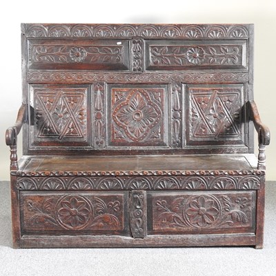 Lot 531 - An 18th century and later carved oak settle