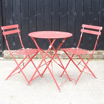 Lot 367 - A red painted metal patio table and chairs