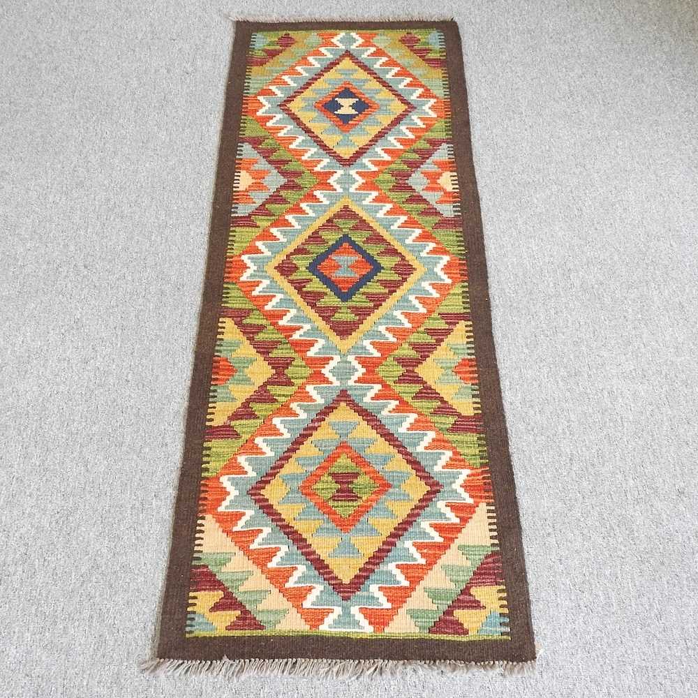 Lot 54 - A kilim runner