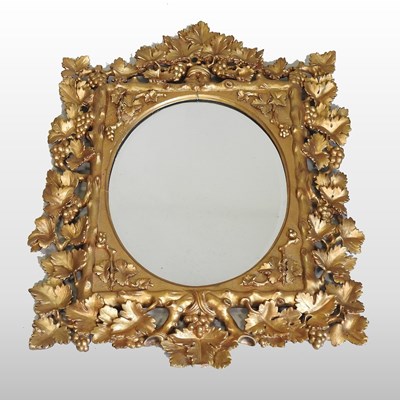 Lot 105 - An ornate carved wood and gilt framed wall mirror