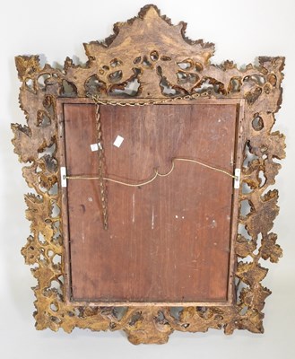 Lot 105 - An ornate carved wood and gilt framed wall mirror