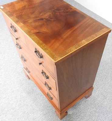 Lot 570 - A reproduction chest of drawers