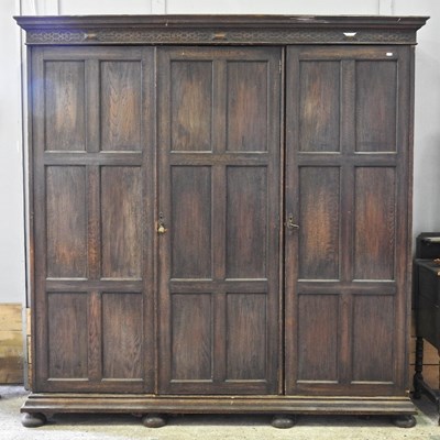 Lot 244 - A Maple & Co oak triple wardrobe, with fitted interior