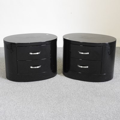 Lot 77 - A pair of black oval bedside chests