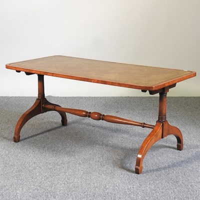 Lot 528 - A walnut leather top coffee table