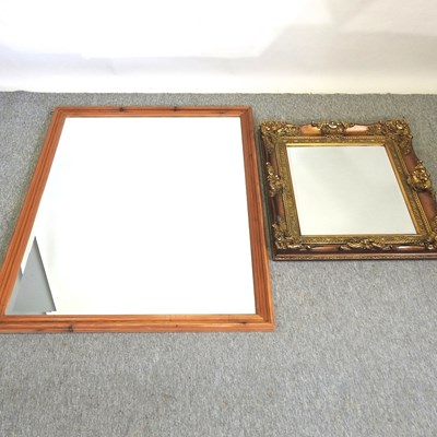 Lot 258 - A large pine framed bevelled glass wall mirror