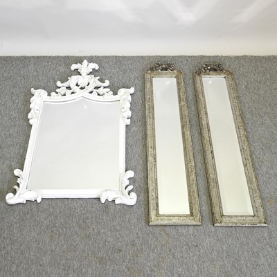 Lot 441 - A pai of ornate silver painted bevelled glass wall mirrors