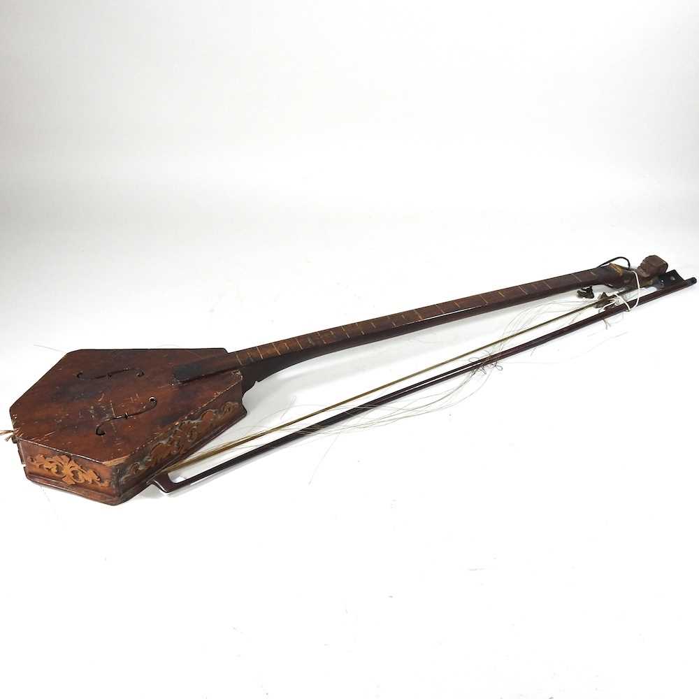 Lot 433 - A one string fiddle and bow