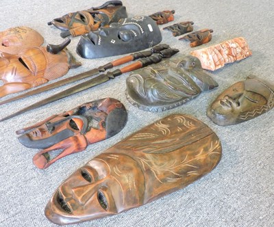 Lot 215 - A collection of carved wooden tribal masks