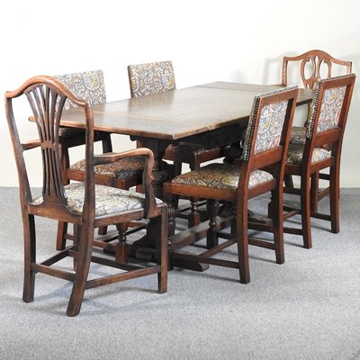 Lot 278 - An oak dining table and chairs