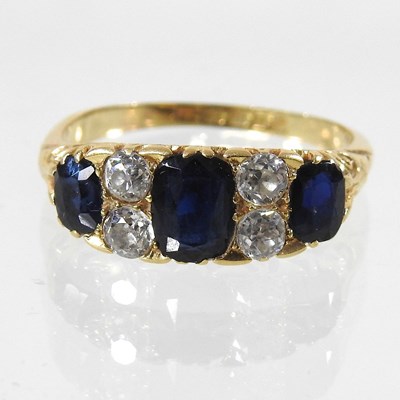 Lot 23 - An 18 carat gold sapphire and diamond ring