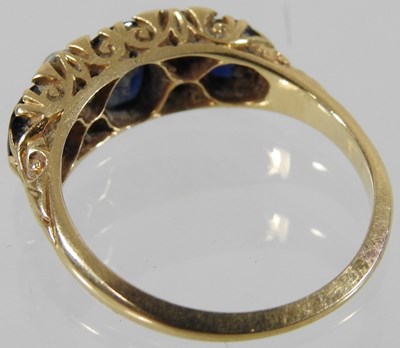 Lot 23 - An 18 carat gold sapphire and diamond ring