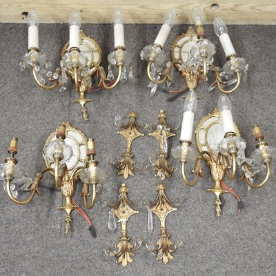 Lot 250 - A set of four gilt twin branch wall sconces