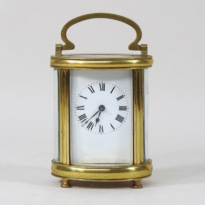 Lot 3 - An early 20th century brass oval carriage clock