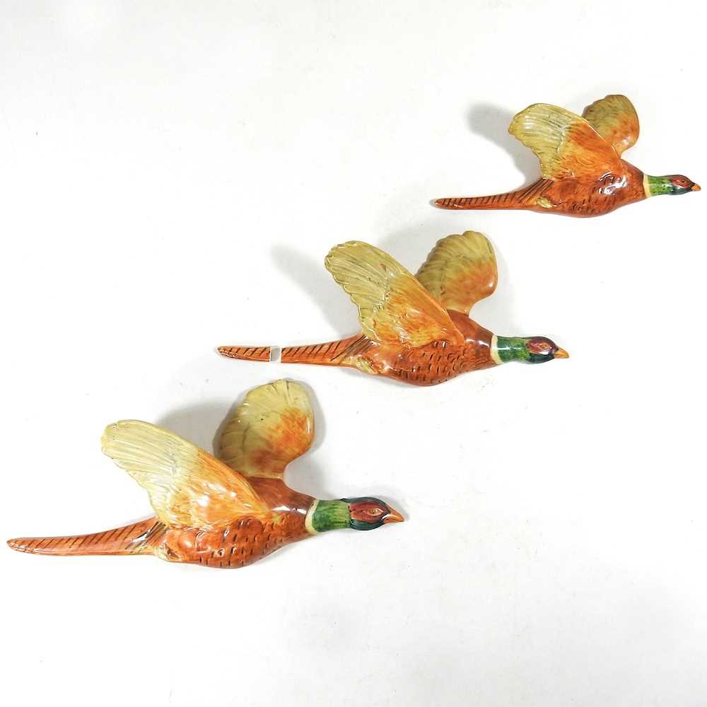 Lot 4 - A set of three Beswick pottery graduated wall mounted flying pheasants