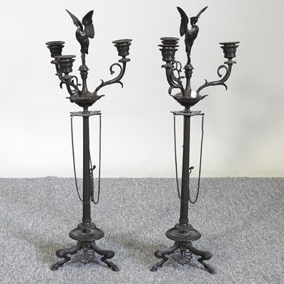 Lot 423 - A pair of bronze candelabra