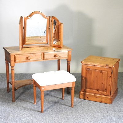 Lot 214 - A pine dressing table, stool and bedside cabinet