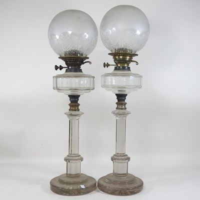 Lot 259 - A rare very near pair of 19th century glass oil lamps