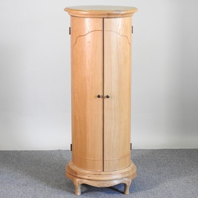 Lot 438 - A cylindrical drinks cabinet