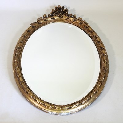 Lot 483 - An oval wall mirror