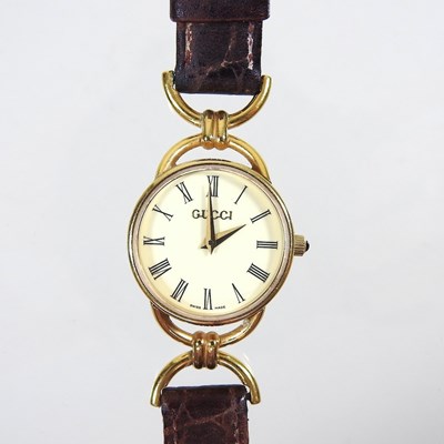 Lot 101 - A Gucci ladies gold plated wristwatch