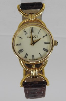 Lot 101 - A Gucci ladies gold plated wristwatch
