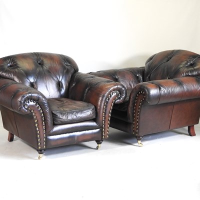 Lot 202 - A pair of brown leather armchairs