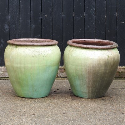 Lot 432 - A large pair of olive glazed garden pots