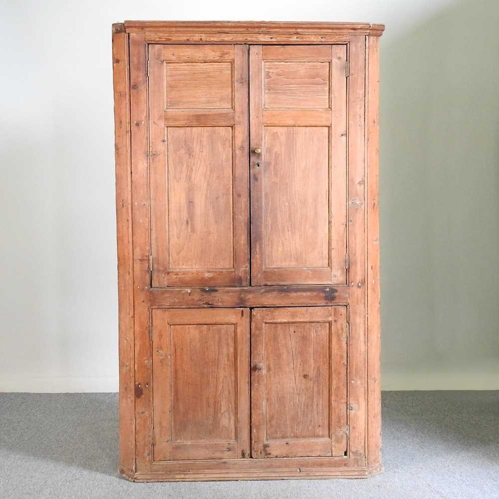 Lot 592 - An antique pine corner cupboard