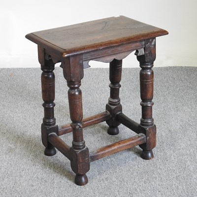 Lot 569 - An oak joint stool