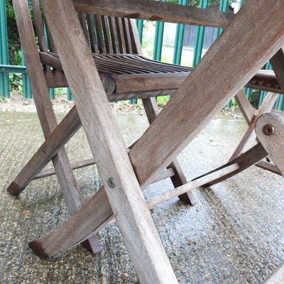 Lot 26 - A teak folding garden table and chairs