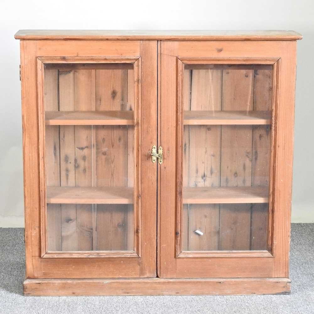 Lot 612 - An antique pine glazed bookcase