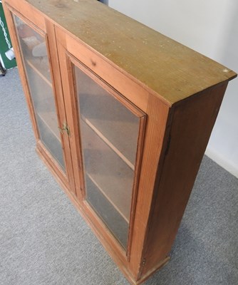 Lot 612 - An antique pine glazed bookcase