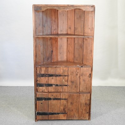 Lot 399 - A rustic pine standing corner cupboard