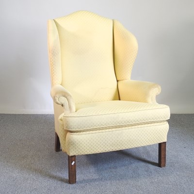 Lot 717 - A wing armchair