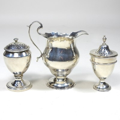 Lot 209 - A silver cream jug and two peppers