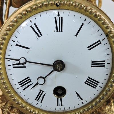 Lot 66 - A gilt mantel clock under a glass dome