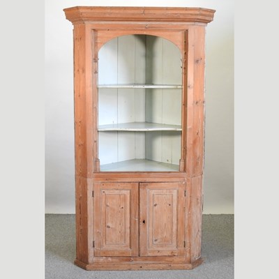 Lot 408 - A George III stripped pine standing corner cupboard