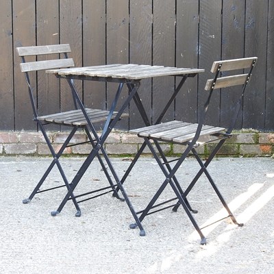 Lot 209 - A patio table and folding chairs