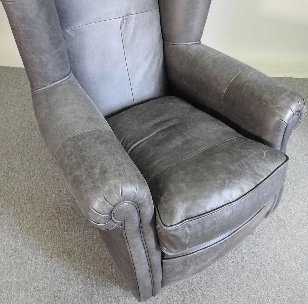 Lot 199 A grey leather armchair