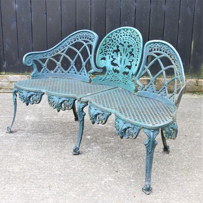 Lot 417 - A green painted cast iron garden bench