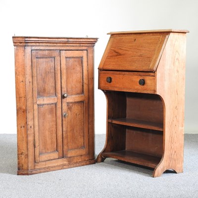 Lot 555 - A George III oak corner cabinet