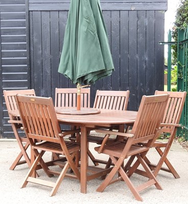Lot 23 - A teak garden table, chairs and parasol