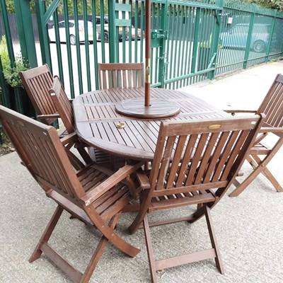 Lot 23 - A teak garden table, chairs and parasol